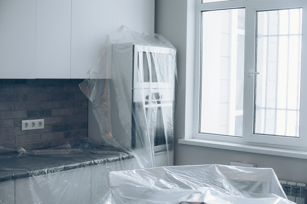 Furniture covered with plastic on the kitchen for window installation