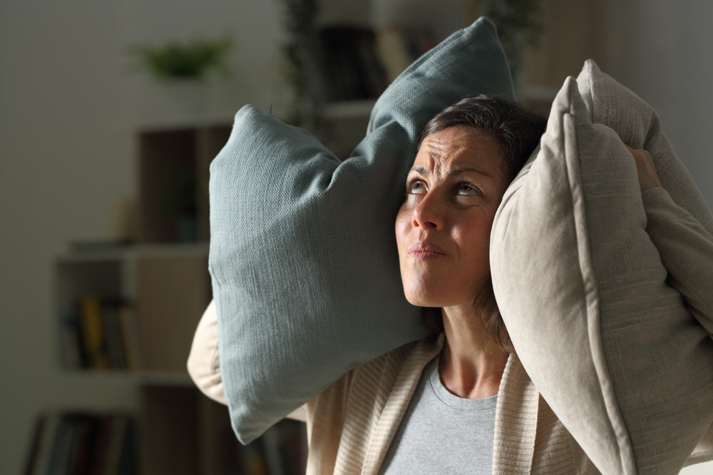 Woman annoyed from loud HVAC system